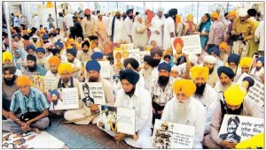 Sikh activists of various Panthic bodies holding portraits of Sikh Martyrs in front of Sri Akal Takht