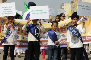 School children  in Ludhiana holding slogans for nature from Guru Granth Sahib.