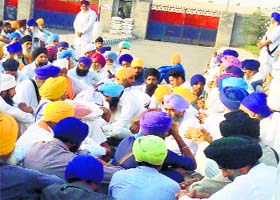 Baljit Singh Daduwal’s supporters sitting outside the closed gate of the jail premises in Faridkot on Thursday