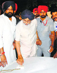 Chief Minister Parkash Singh Badal presses a button to set an effigy of Ravana on fire in Malout on Friday (Oct. 03)