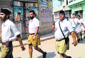 RSS activists brandish firearms during a street march in Faridkot’s Jaitu town on Oct. 05, 2014