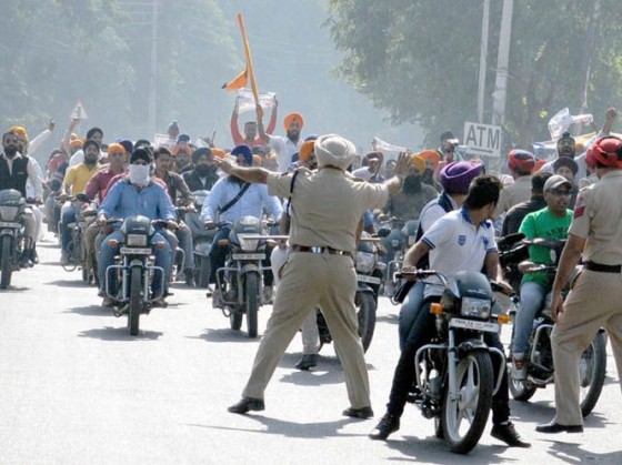 Police personnel trying to stop youth who were taking out a march in Jalandhar city
