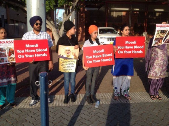 Protesters display placards during protest against Indian Prime Minister Narendra Modi in Sydney (Nov. 17, 2014_