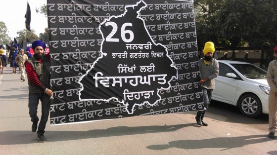 Sikh youth activists carry a display board terms 26 January as "Betrayal Day"