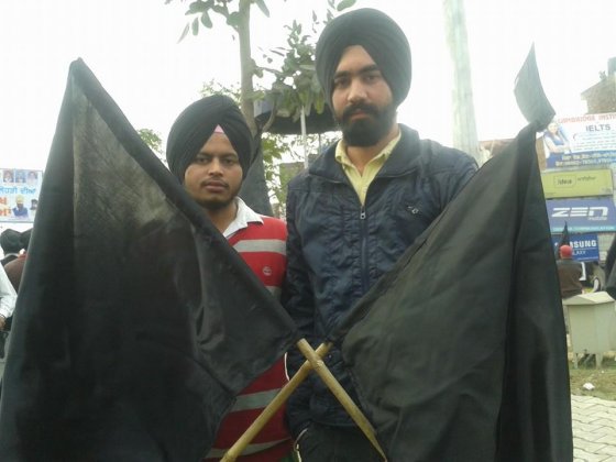 Sikh  youth activists demonstrate with black flags on India's republic day