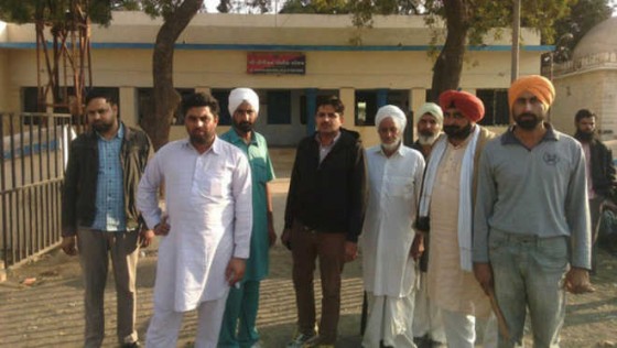 The Punjabi farmers who were attacked stand outside a police station in Bhuj, Gujarat, on Saturday (Jan 25, 2015)