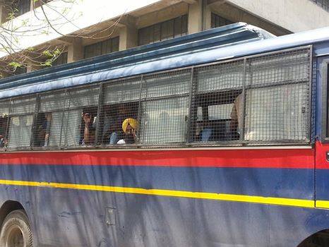 Ravinder Jeet Singh Gogi being brought to the court complex in Police bus