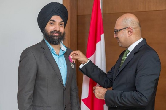 Mandeep Singh, left, receives a decoration for bravery from Arif Lalani, Canadian Ambassador to the UAE, in Abu Dhabi