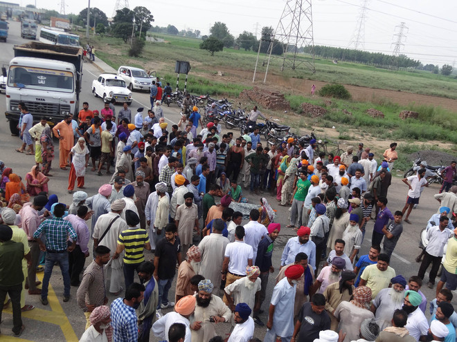 Villagers gather to protest