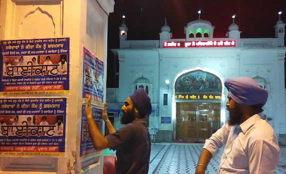 Activists of the Sikh Youth of Punjab pasting posters calling for boycott of persons holding positions of Sikh Jathedars