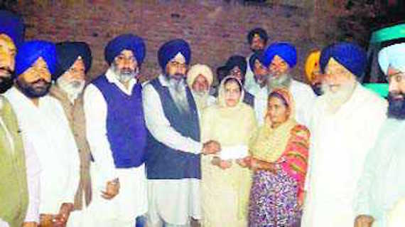 Badal leaders hand over a relief cheque to the family of a firing victim in Faridkot on Monday