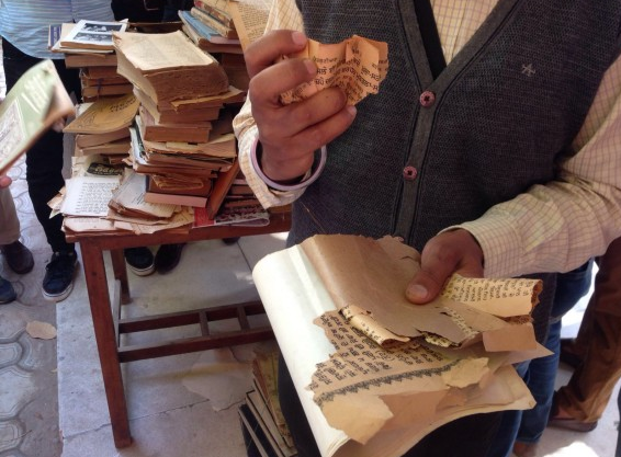 A student shows copy of a rare Punjabi magazine torn by university Librarian 