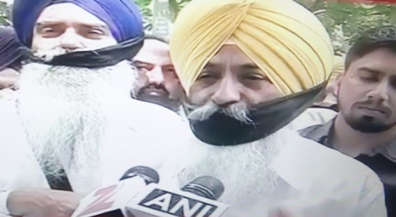 Balwinder Bains speaking to media during the protest