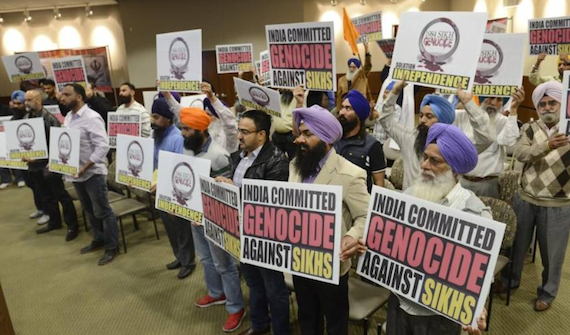 Members of the Sikh community hold up signs denouncing the mass killing of Sikh people in India in 1984, following a vote by the Kerman city council to formally acknowledge the violence as a genocide. CRAIG KOHLRUSS