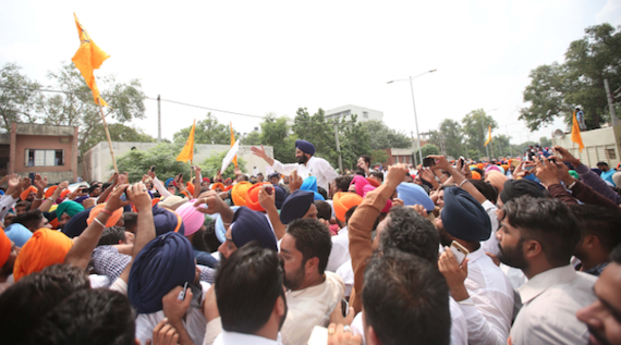 Bikram Majithia waives his hand towards his supporters