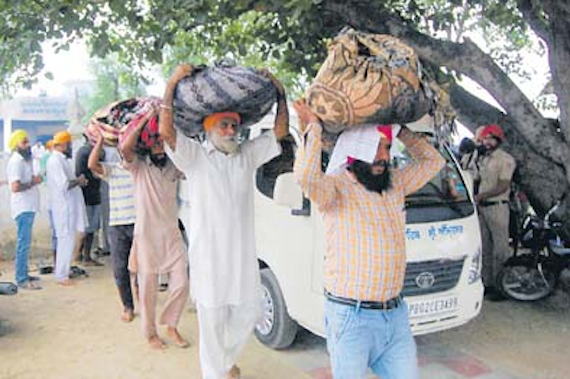 Residents of village Mirankot taking the burnt Saroops of Guru Granth Sahib to Goindwal Sahib