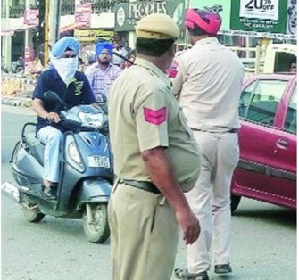 Police stop a rider who had his face covered