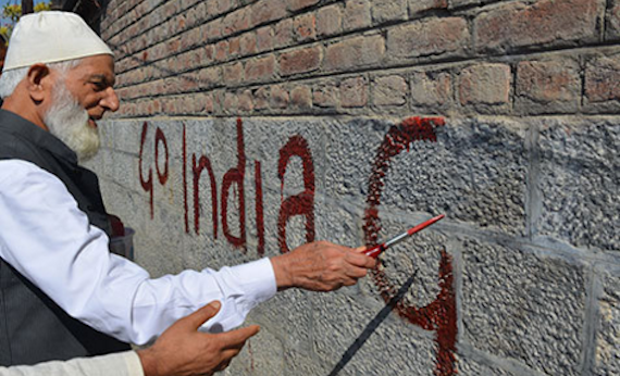 SAS Geelani paints 'Go India, Go Back' on a wall in Hyderpora